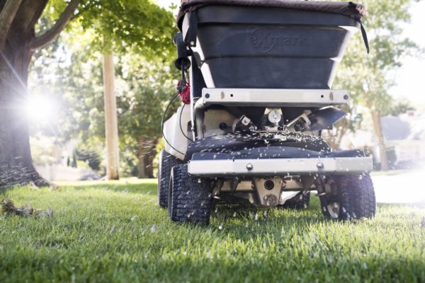 Ex-Mark Stand-On Sprayer lawn care applicator at work, spraying a lawn.