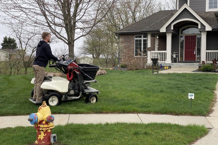 A PRO-TURF Services lawn care professional maintains a residential yard.