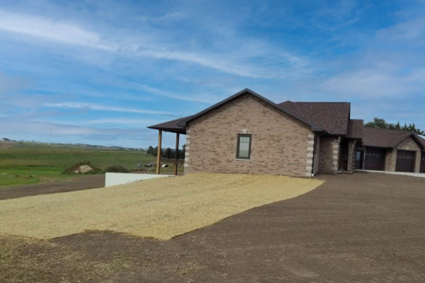 Side yard and front yard of a residential home undergoing seeding and erosion control.